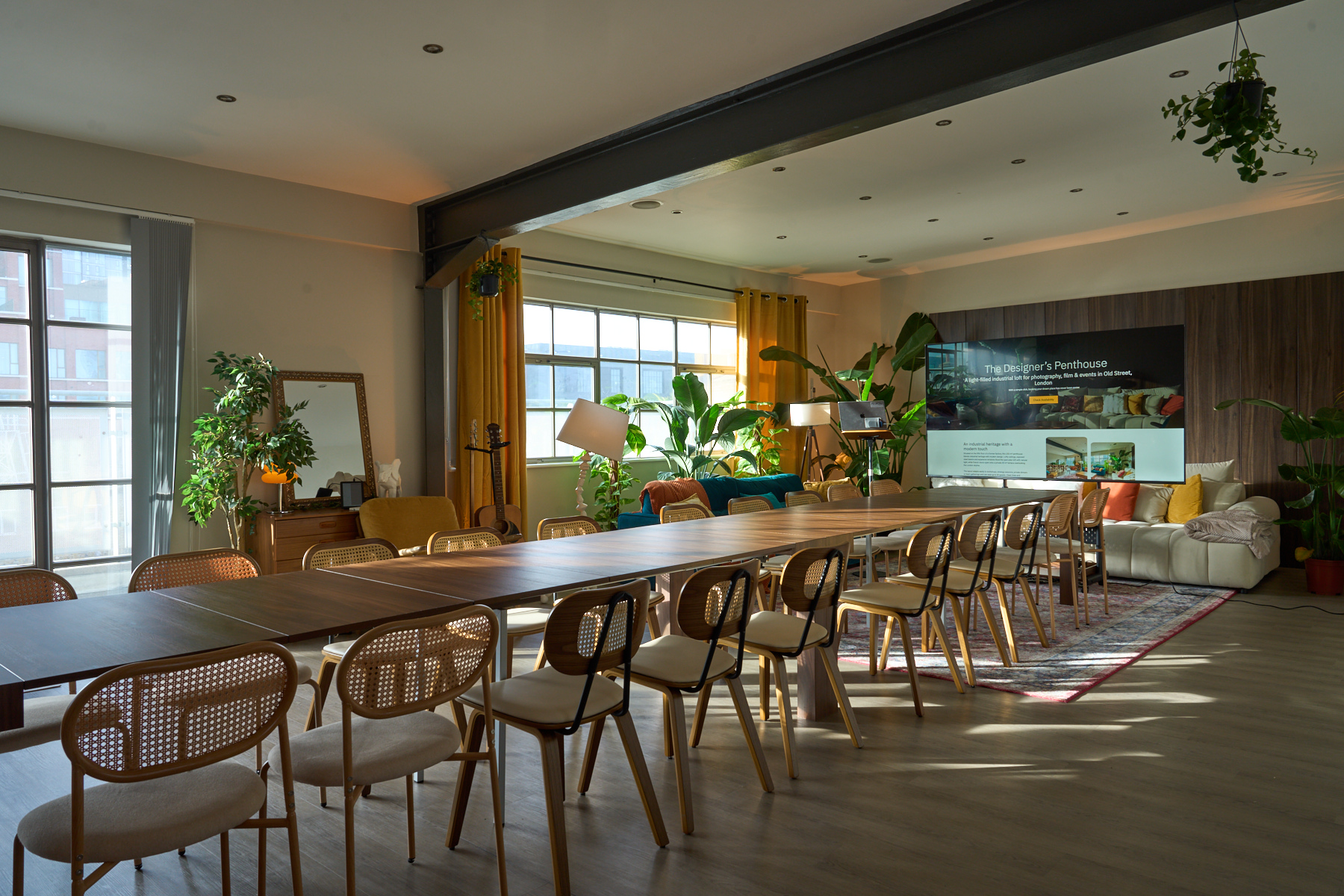 Long-table meeting configuration in The Designer's Penthouse, Old Street, ready for daylight and AV