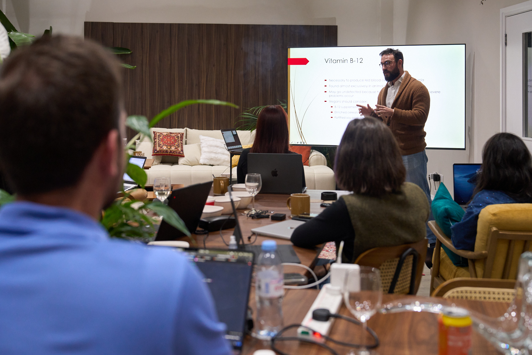 People gathered for a meeting in the industrial penthouse event space, Old Street London