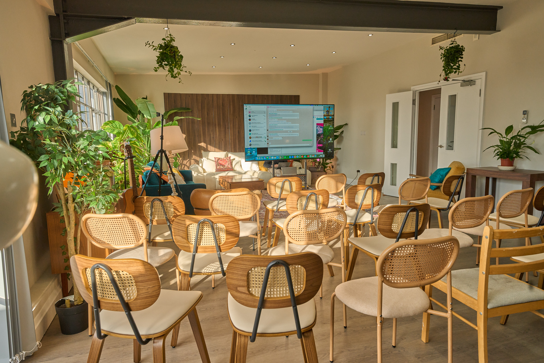 Workshop seating arrangement with natural light for an off-site or training setup at The Designer's Penthouse