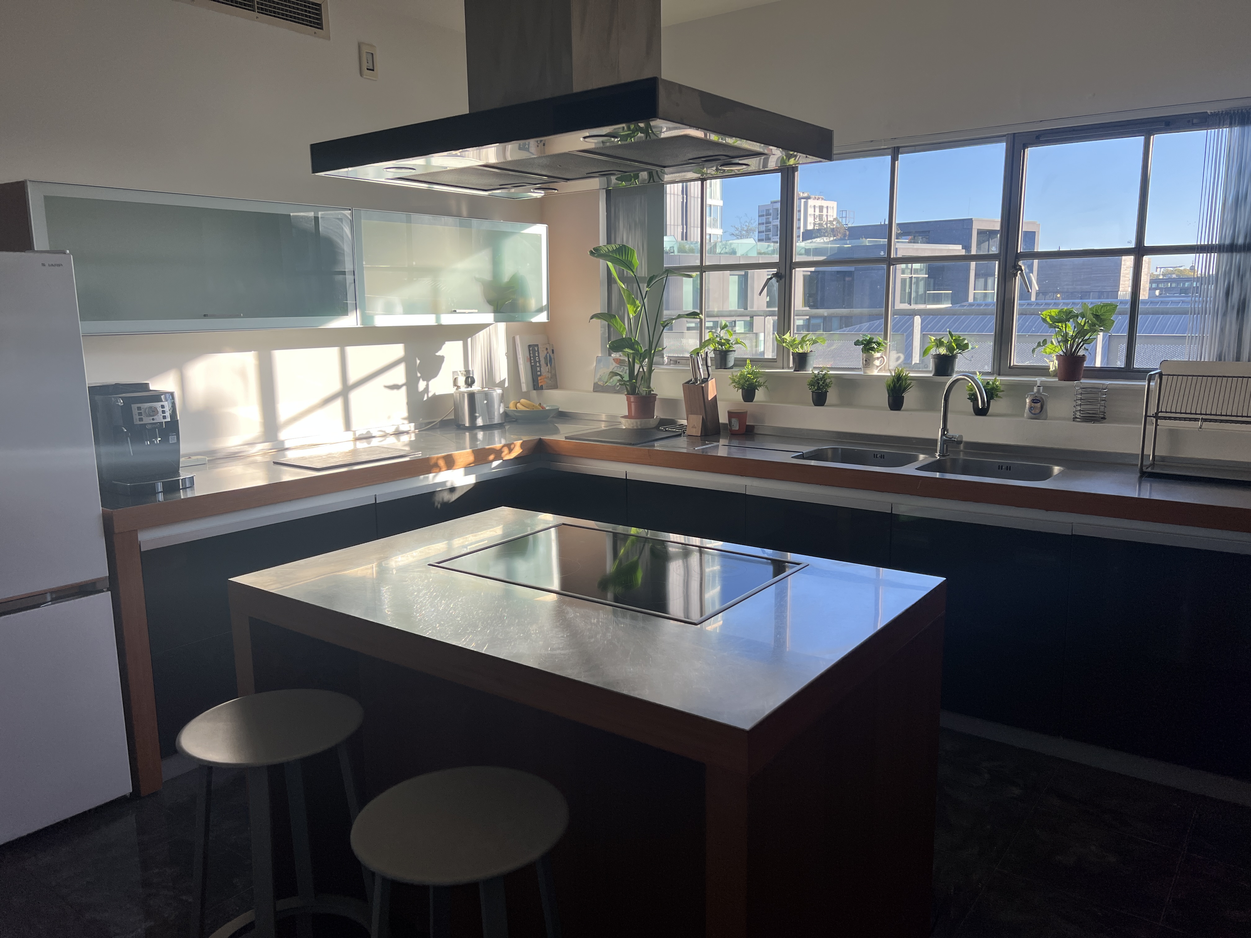 Fully equipped kitchen with oven, hob, and modern worktops in the Old Street penthouse