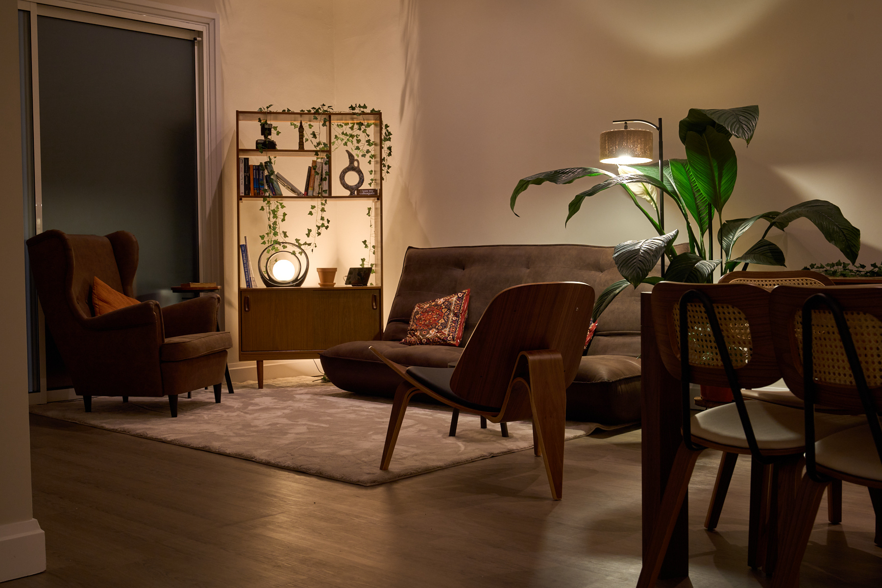 Library corner with curated books and shelving, a styled reading nook in the penthouse studio