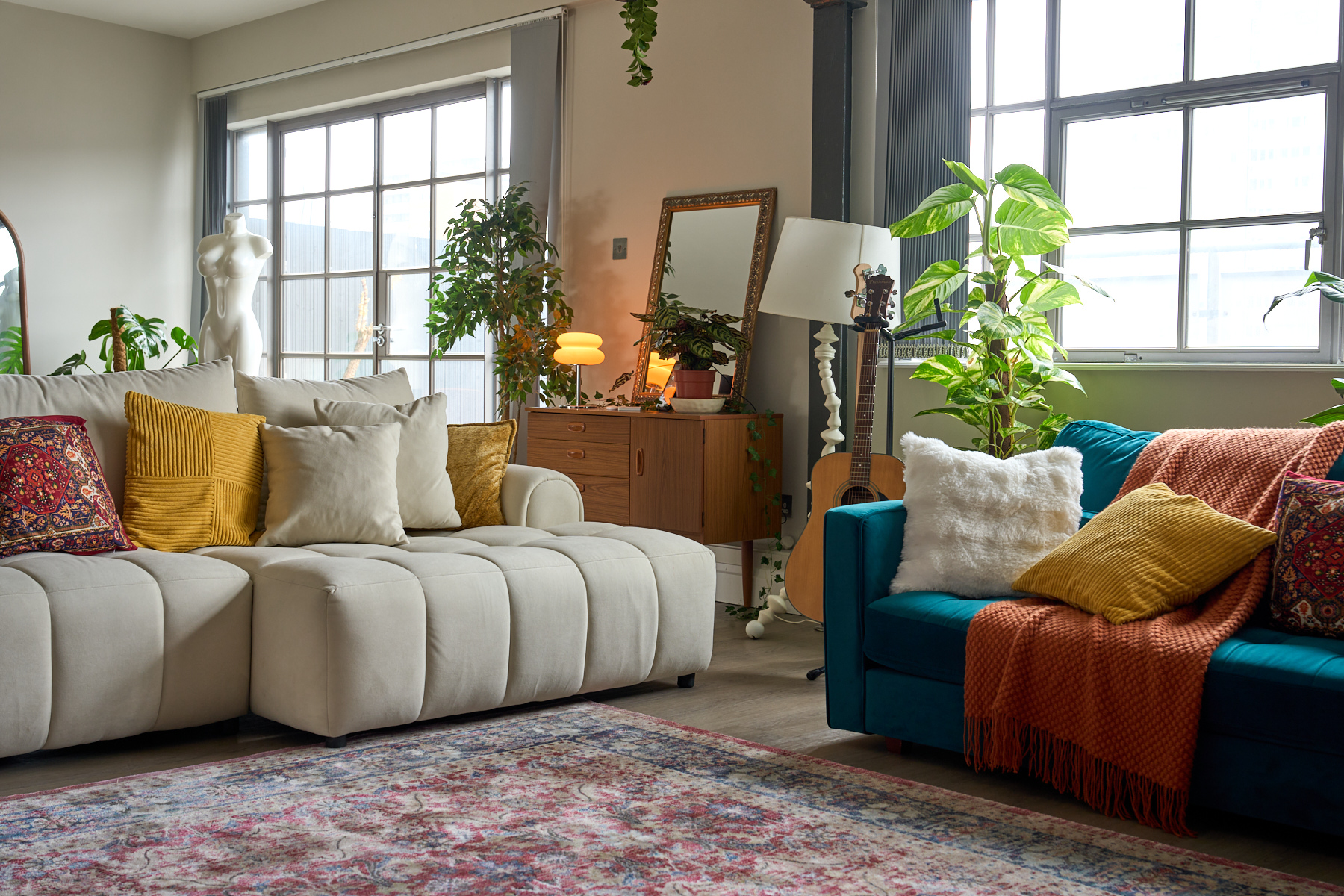 Designer sofa and furniture in warm tones within the elegant lounge area at The Designer's Penthouse