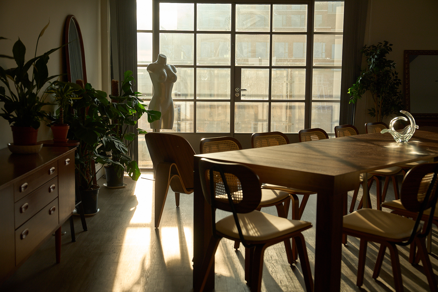 Table and plants catching south-facing daylight in an interior styling moment at The Designer's Penthouse