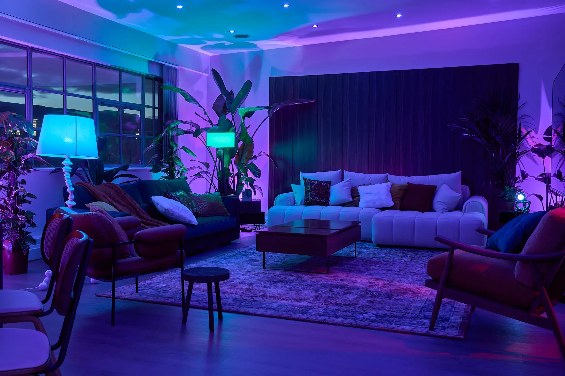 Evening ambiance in a Shoreditch penthouse with colored lighting, ideal for creative events and private parties.