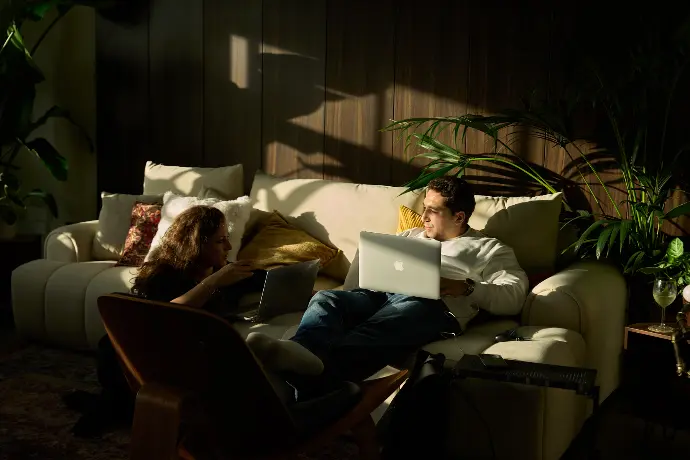 Evening event ambiance in a London penthouse with guests, soft lighting, and relaxed atmosphere.