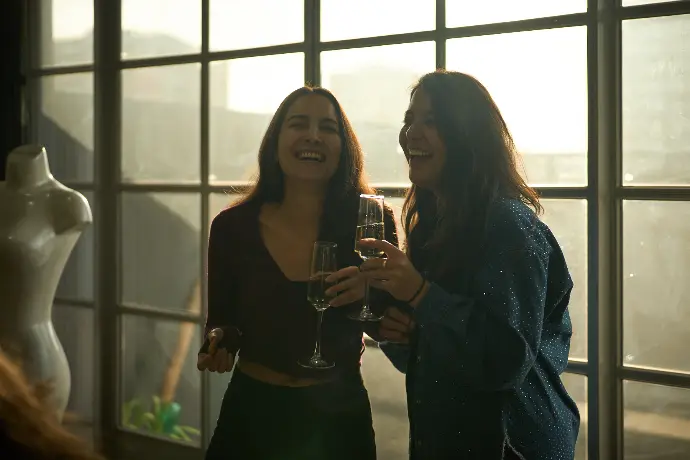 Champagne toast during an event in a Shoreditch penthouse, capturing genuine social moments.