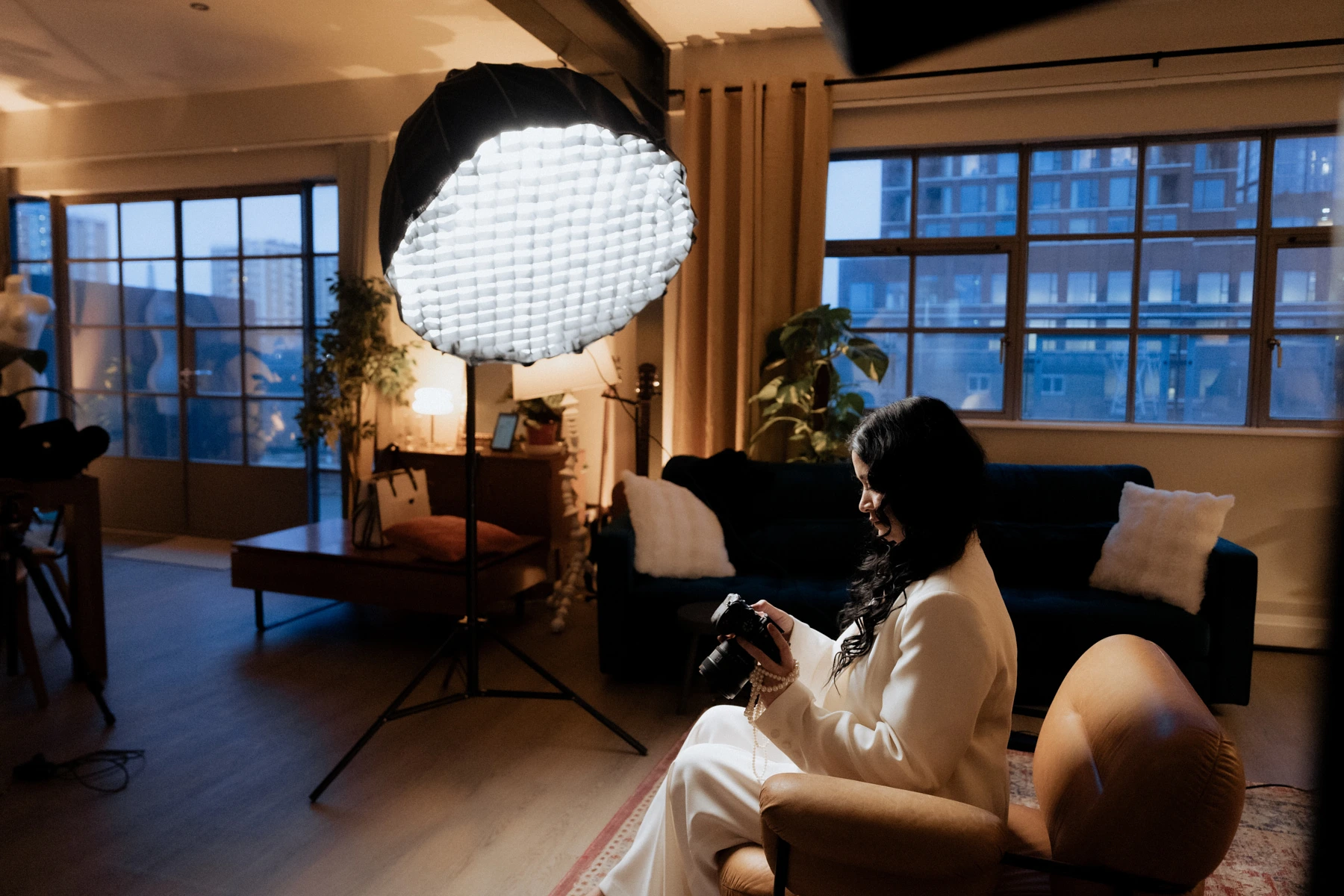Behind-the-scenes photoshoot in a Shoreditch penthouse with professional lighting and camera setup.