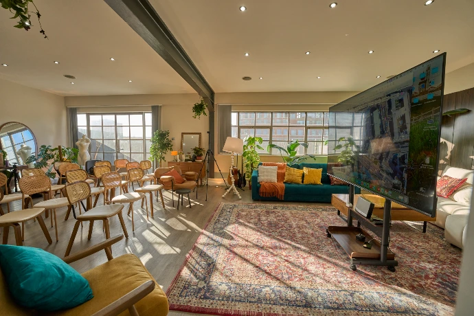 Bright industrial penthouse in Shoreditch with large dining table, plants, natural light and flexible layout for workshops, meetings and private events.